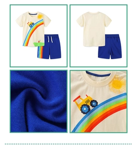 Detail of kids knit cotton summer set with rainbow and tractor print on beige tshirt