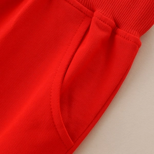 Kids autumn cotton sport pants in vibrant red featuring ribbed waist and side pocket detail