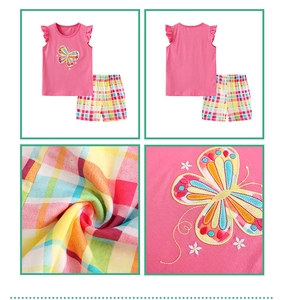 Detail of pink embroidered butterfly vest and colorful plaid cotton shorts set for girls