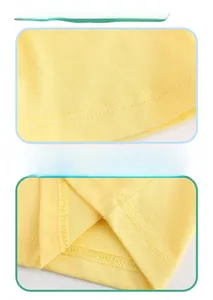 Detail of double-needle stitching on yellow cotton sleeves and hem of the boys' t-shirt