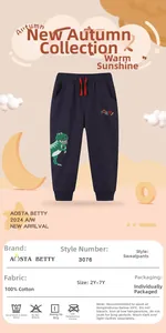 Detail of 100% cotton navy kids sweatpants with green dinosaur embroidery and red drawstring