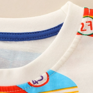 Detailed view of white cotton boy's t-shirt with colorful numeric sports prints and blue collar