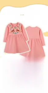 Detail showing exquisite reindeer and mushroom embroidery on soft pink cotton dress