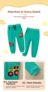 Detail of green boys' joggers with yellow tractor embroidery and elastic ribbed cuffs