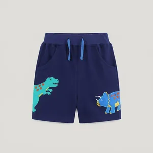 Dettaglio di pantaloncini blu scuro per bambini con stampe di dinosauri e coulisse blu