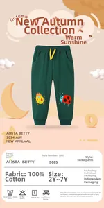 Detail of dark green cotton kids sweatpants featuring cartoon beetle embroidery and yellow drawstring
