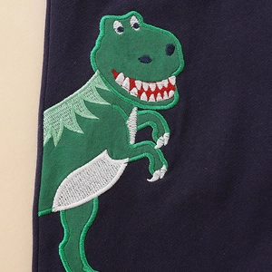Navy blue boys' knit pants featuring detailed green dinosaur embroidery on soft cotton fabric