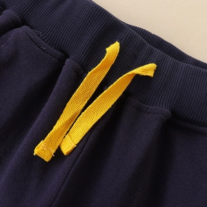 Boys navy knit joggers with ribbed elastic waist and vibrant yellow drawstring detail