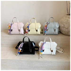 Detailed arrangement of five colorful PU leather handbags with decorative beaded charms