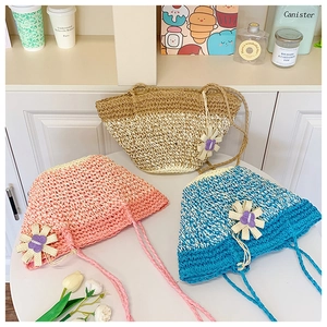 Detailed macro of small woven straw bags with colorful 3D flowers in beige, pink, and blue