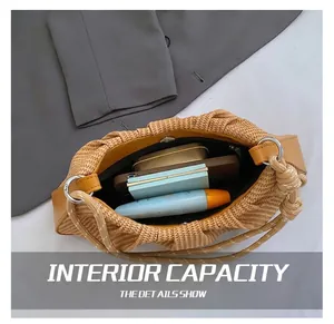 Top view of pleated khaki woven handbag interior showing spacious capacity for phone and items