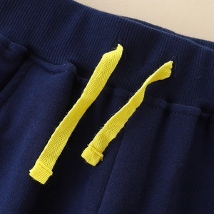 Boys navy blue cotton sweatpants with elastic ribbed waist and yellow drawstring cord
