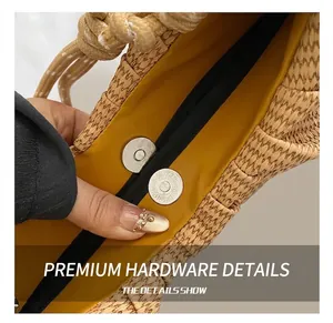 Detail of woven straw handbag featuring magnetic silver clasp and yellow lining