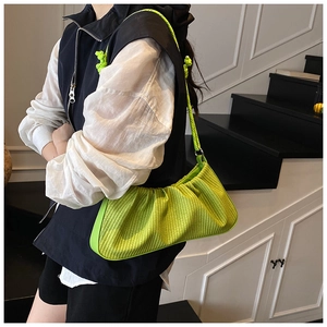 Detail of neon green cloud bag with woven texture and yellow climbing rope strap