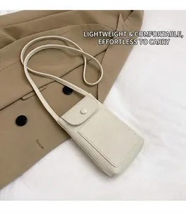 Detail showing creamy white litchi pattern leather phone bag with snap closure and strap