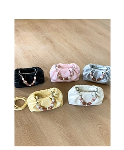 Top view of pleated bucket bags in five colors with pearl handles and metal zippers