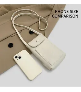 Detailed view of beige pebble leather phone bag showing size scale next to a smartphone