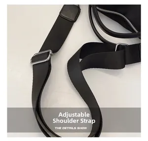 Detail of adjustable black nylon shoulder strap with a polished silver metal buckle