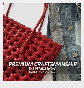 Detailed close-up of red hollow woven pattern and leather texture on a summer beach bag