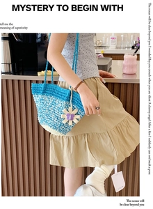 Blue and white gradient woven straw bag with handmade flower charm accessory