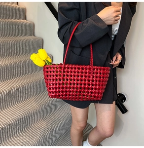 Close-up of red hollow woven tote bag with tulip flowers in a lifestyle setting