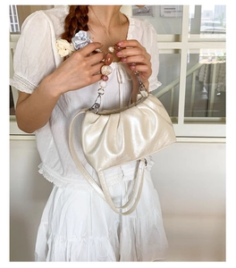 Detail of ruched cream bucket bag with marble acrylic beads and detachable strap