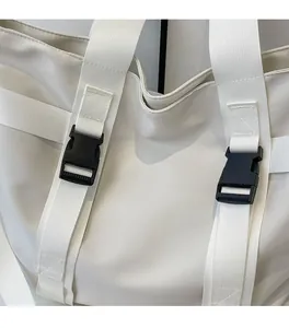 Detail of the high-quality buckle and webbing on the large ivory canvas tote bag