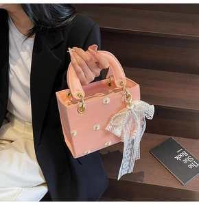 Detailed pink leather bag featuring daisy embroidery and elegant lace bow charm
