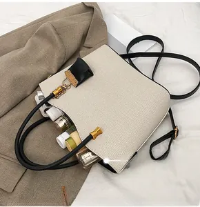 Spacious beige woven tote bag interior showing multiple skincare products and gold hardware