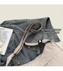 Detail of adjustable shoulder strap and nylon fabric texture on a beige crossbody bag