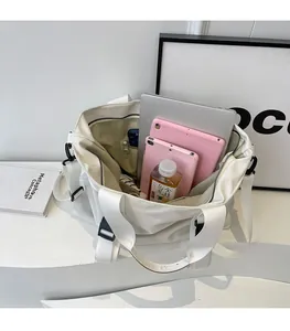 Top view of white canvas tote bag showing spacious interior with laptop and compartments
