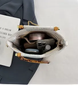 Spacious interior of floral lace handbag showing storage for phone and cosmetics