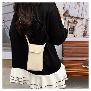 Detail of cream lychee texture leather mini crossbody phone bag with flap and button
