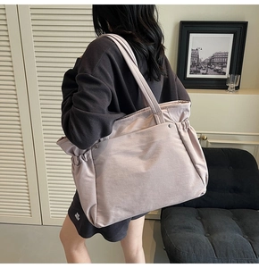 Vue détaillée du sac cabas en toile avec côtés à cordon et doubles poignées renforcées