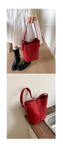 Detailed macro view of red lychee textured leather bucket bag with metal buckle adjustment