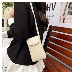 Chic beige lychee leather phone bag with flap buckle shown in a lifestyle crossbody view