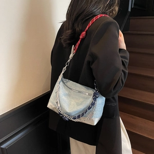 Detail of glitter shoulder bag with braided rope strap and metallic chain accents