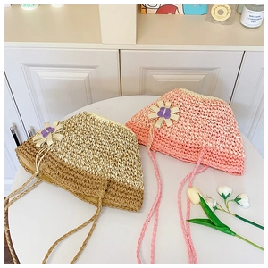 Detail of straw hats with hollow weave, fabric sunflowers, and long matching ties