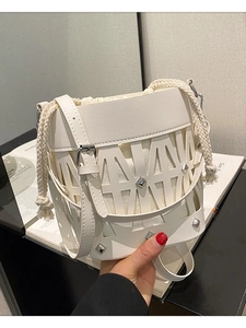 Fashionable hollow bucket bag in beige with metal studs and drawstring canvas lining