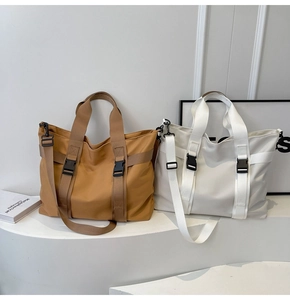 Macro shot of durable nylon material and buckle details on khaki and white tote bags