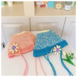 Detail of handmade knit sun hat with floral pattern and soft woven straps for kids