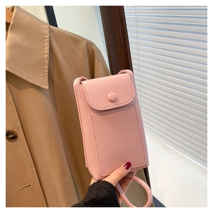Detailed close-up of pink litchi textured phone bag with secure flap and snap button closure