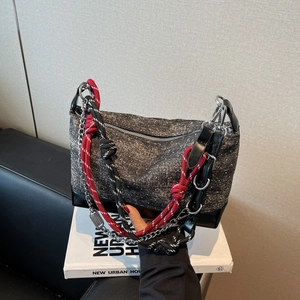 Detail of grey tweed tote bag with metal chain and colorful climbing rope shoulder strap