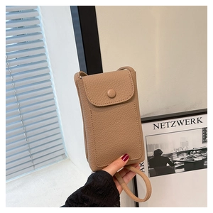 Detail of khaki lychee leather mini crossbody bag with matching round buckle and strap