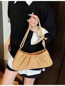 Light brown pleated straw shoulder bag with knot strap detail and crescent moon shape