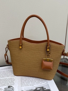 Retro large straw woven tote bag with brown leather handles and mini bag charm accessory
