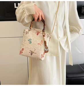 Detail view of the vintage bamboo handle and embroidery on the elegant lace purse