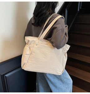 Détail du grand cabas beige avec cordon de serrage et texture en nylon effet froissé