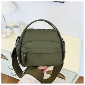 Olive green nylon crossbody bag with wide strap and round handle for daily use