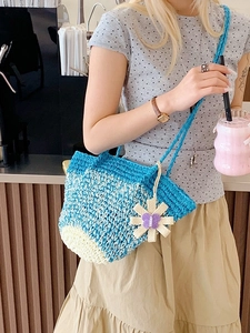 Handmade crochet woven shoulder bag in blue and white patterns with flower charm